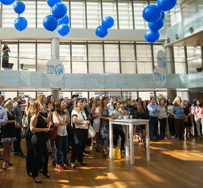 old maala conference, people standing looking at the screen